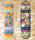 Two colorful skateboard decks with artistic designs and text on a wooden surface. Drawing Boards, A Wabi-Sabi, Series, Grey, White, 8.5, Level Skateboards, Brighton, Local Skate Shop, Independent, Skater owned and run, south coast, Level Skate Park.