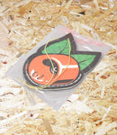 Car air freshener with cherry design on a bed of wood shavings