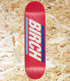 A red skateboard deck with a bold graphic design featuring the word 'BIRCH' in large white letters, flanked by light blue and dark blue vertical stripes, set against a background of shredded wood chips.